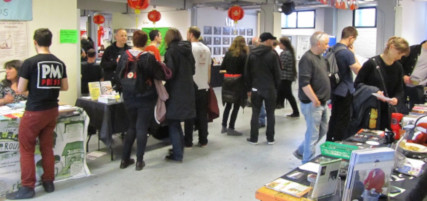Photograph of several people browsing stalls at the bookfair
